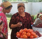 Woman uses cell phone at the market - Tajikistan. By Kate Dixon.