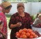 Woman uses cell phone at the market - Tajikistan. By Kate Dixon.